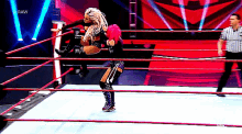 two women are wrestling in a ring with the word raw on the bottom right