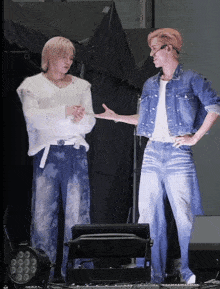 two men standing next to each other with their hands on their hips talking