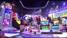a group of girls are dancing on a stage with a sign that says likey on it