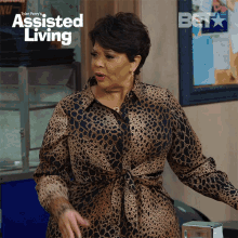 an advertisement for tyler perry 's assisted living features a woman in a leopard print dress