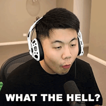 a man wearing headphones and a microphone is asking what the hell
