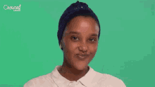 a woman with a turban on her head is rubbing her face with her hands .