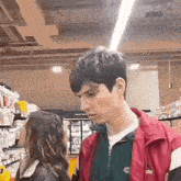 a man and a woman are standing next to each other in a store .