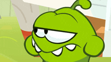 a close up of a green cartoon character with big eyes and teeth