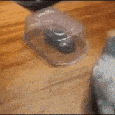 a bird is playing with a toy car in a plastic container
