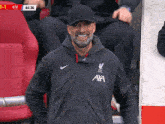 a man wearing a jacket that says axa on the front