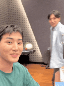 a man in a green shirt is taking a selfie