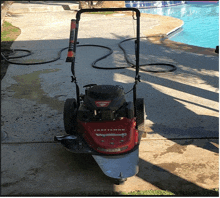 a craftsman lawn mower is sitting on a sidewalk