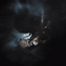 a blurry picture of a person 's face with a hand reaching out