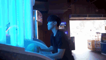 a man is playing a game in an arcade with a sign that says ' arcade ' on it