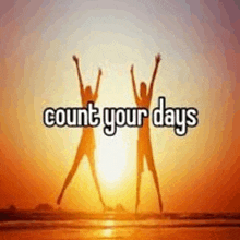 a picture of two people jumping in the air with the words `` count your days '' in the background .