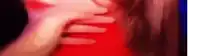 a close up of a person 's hands on a red shirt .