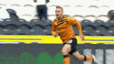 a soccer player wearing a number 10 jersey is running on a field .