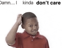 a boy in a red shirt is scratching his head with his hand .