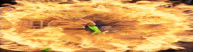 a person in a green shirt is surrounded by a large explosion of flames .