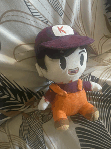 a stuffed toy with a red k on it 's hat