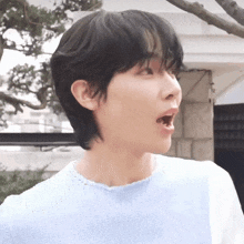 a close up of a person wearing a blue sweater with their mouth open