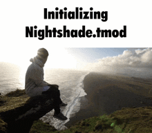 a man sits on the edge of a cliff overlooking the ocean with the words initializing nightshade.tmod below him