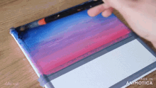 a person is painting a picture on a canvas with the words made in animatica on the bottom right