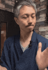 a man wearing a blue robe with a microphone on it