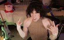 a woman with a cast on her arm is making a rock sign