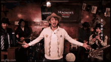 a man with his arms outstretched in front of a guinness sign
