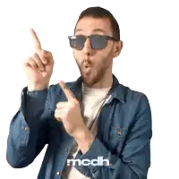 a man wearing sunglasses and a denim shirt with the word mcdh on the bottom