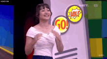 a woman is standing in front of a sign that says lol on it