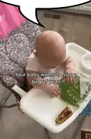 a baby is sitting in a high chair with a bag of peas in front of him