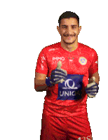 a man wearing a red immo united jersey