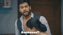 a man with a beard is standing next to a woman and says ammaaaa !