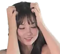 a woman is scratching her head with her hands while smiling