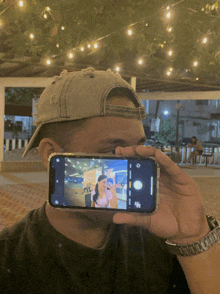a man is taking a picture of a woman on his cell phone