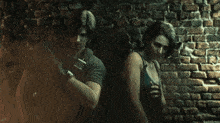 a man and a woman are standing next to each other in front of a brick wall in a dark room .