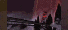 a blurry picture of a person standing in front of a fire with a red background .