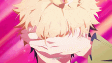 a man with blonde hair is covering his face with his hands