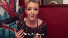 a woman says bitch puh-lease in front of a spider man painting