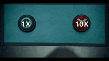 two buttons on a wall with one saying 1x and the other saying 10x .