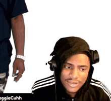 a man wearing headphones is smiling in front of a white background that says aggiecuhh on it