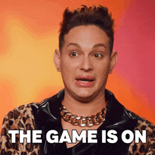 a man wearing a leopard print jacket and a gold chain necklace says the game is on