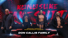 a group of men standing in front of a sign that says konosuke takeshita never openweight champion