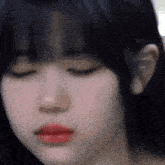 a close up of a woman 's face with her eyes closed