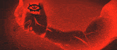 a red background with a black border and a triangle in the center
