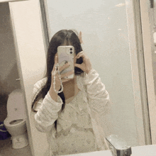a woman is taking a picture of herself in a mirror