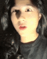 a close up of a woman 's face with a surprised expression