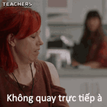 a woman with red hair is sitting in front of a counter with the words teachers written on the bottom