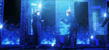 a couple of anime characters standing next to each other in a dark room