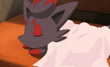 a cartoon drawing of a black and red animal laying on a white blanket
