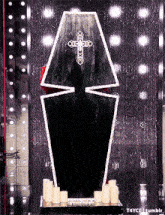a black coffin with a white cross on the top