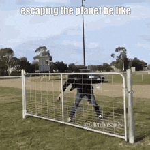 a man standing behind a fence with the words escaping the planet be like